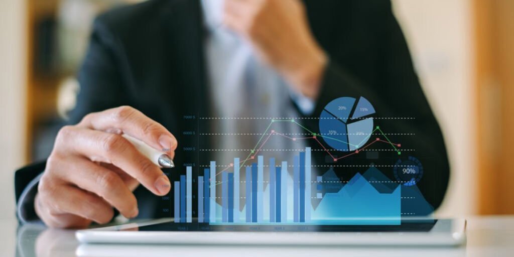 A Man with a formal shirt using tab and analyzing the graph of growth.